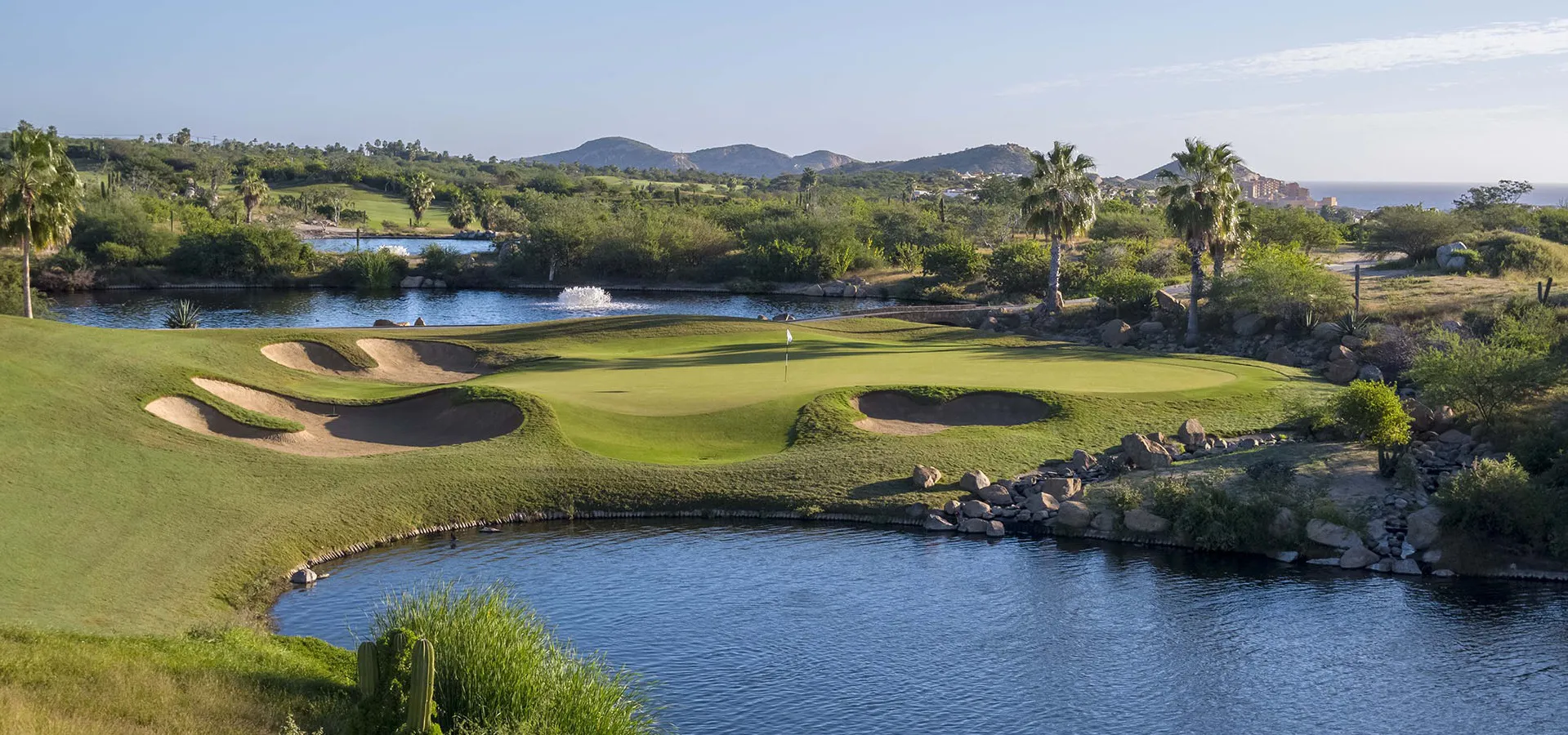 Immaculate green fairways and coastal luxury villas showcasing the resort-style lifestyle at Cabo del Sol, Cabo San Lucas.