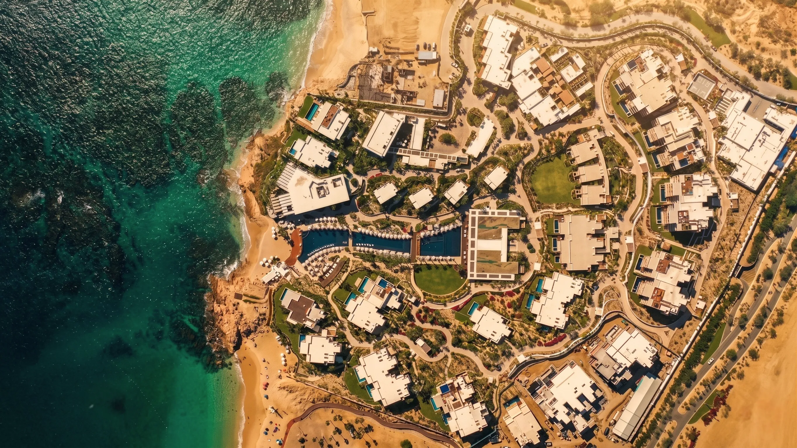 Stunning high-angle aerial perspective highlighting the master-planned layout and luxury real estate architecture at Chileno Bay.