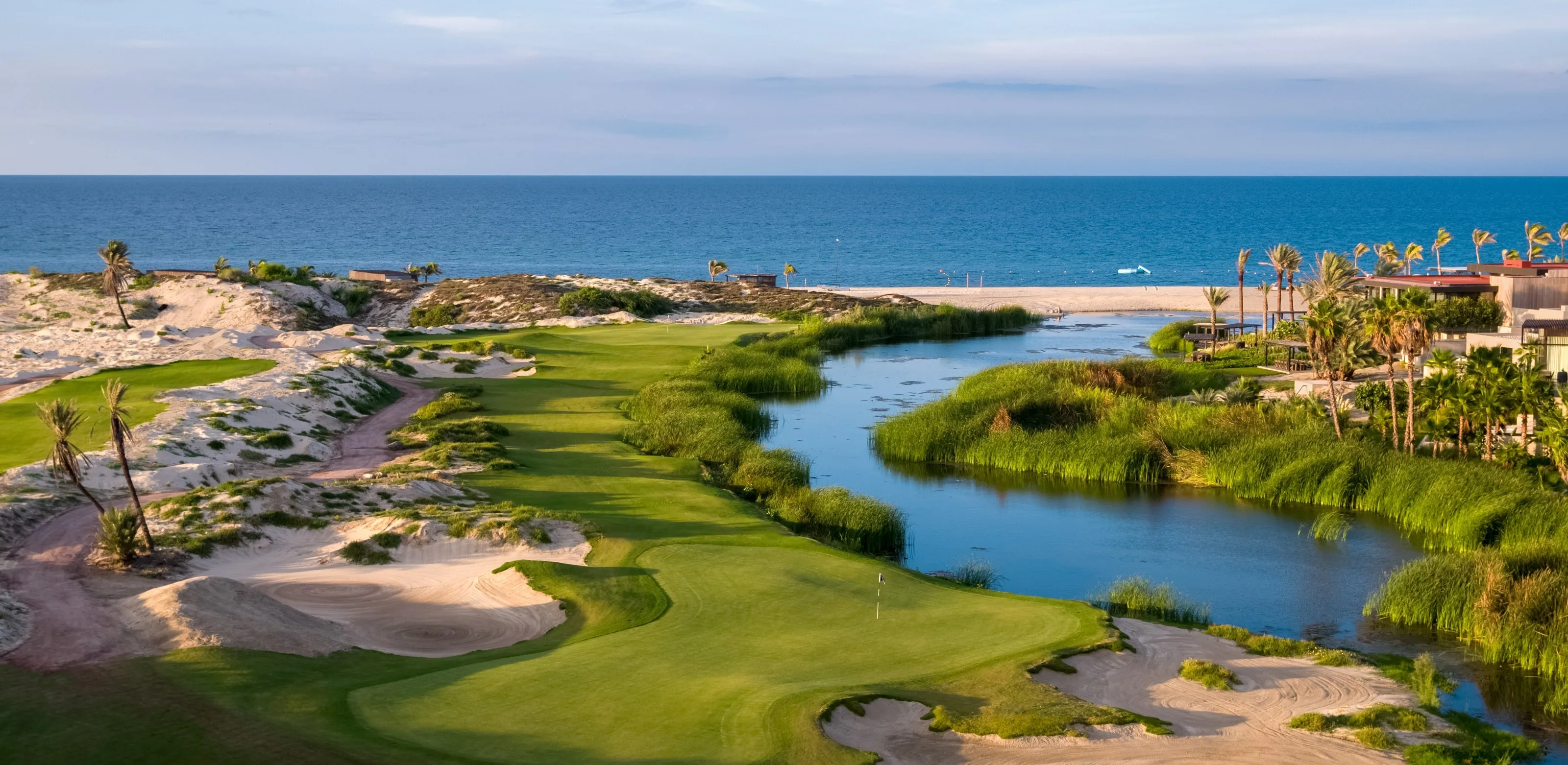 Spectacular aerial view of the Robert Trent Jones II championship golf course greens and fairways surrounded by desert landscapes at Costa Palmas.