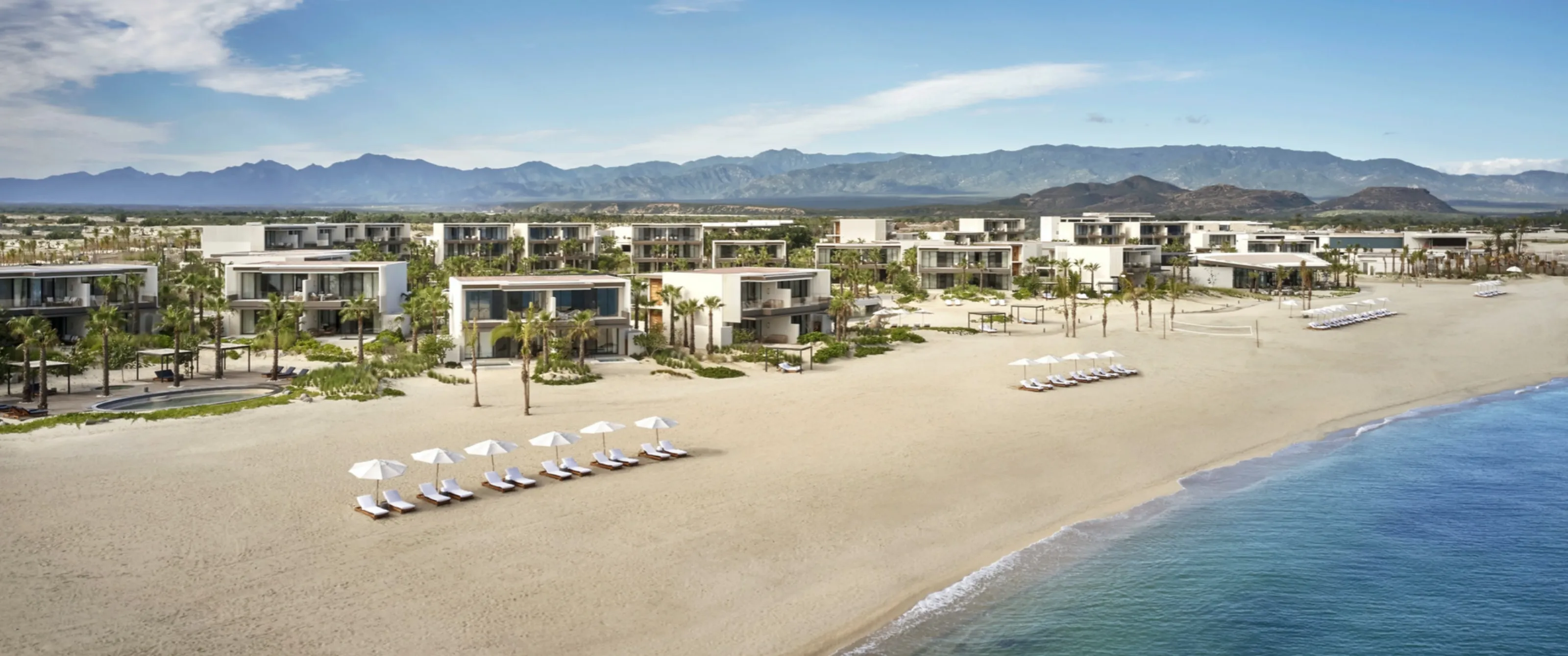Panoramic beachside overview of the architectural design and infinity pools at the ultra-exclusive luxury resorts in Costa Palmas, Los Cabos.