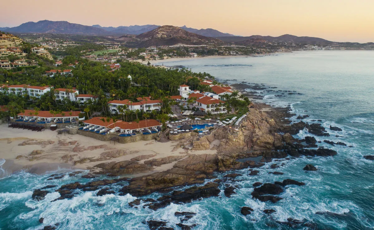Panoramic high-altitude aerial view of a premier 5-star oceanfront luxury hotel resort in Palmilla, Los Cabos.
