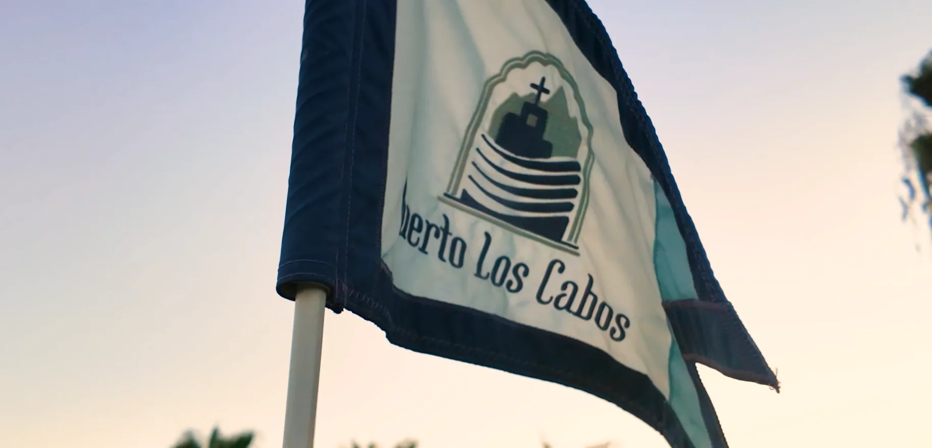 Close-up of a Puerto Los Cabos branded flag on the 27-hole dual-signature golf course designed by Jack Nicklaus and Greg Norman.