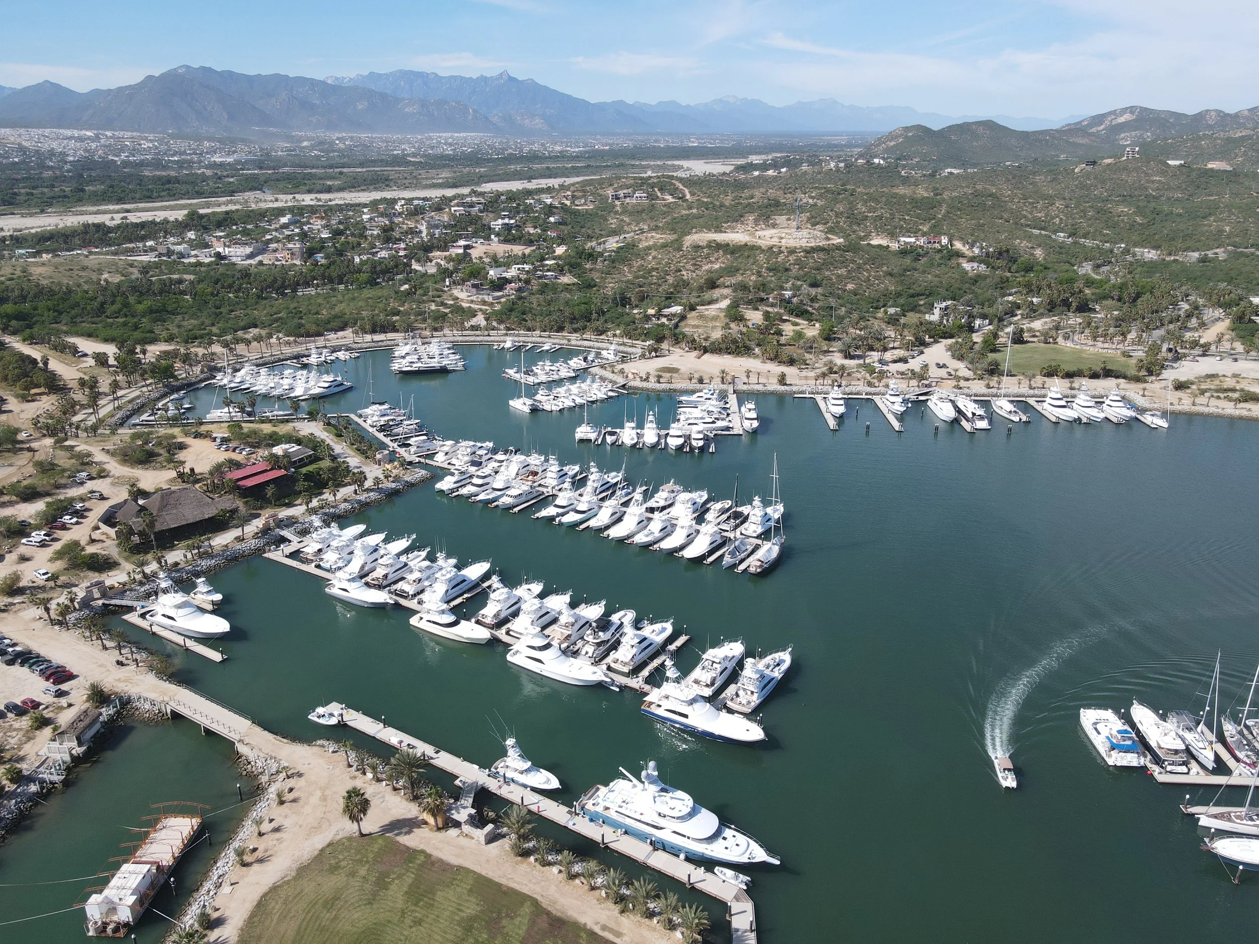 Wide aerial view of the sophisticated 200-slip private marina in Puerto Los Cabos filled with luxury yachts and sportfishing boats. Wide aerial view of the sophisticated 200-slip private marina in Puerto Los Cabos filled with luxury yachts and sportfishing boats.