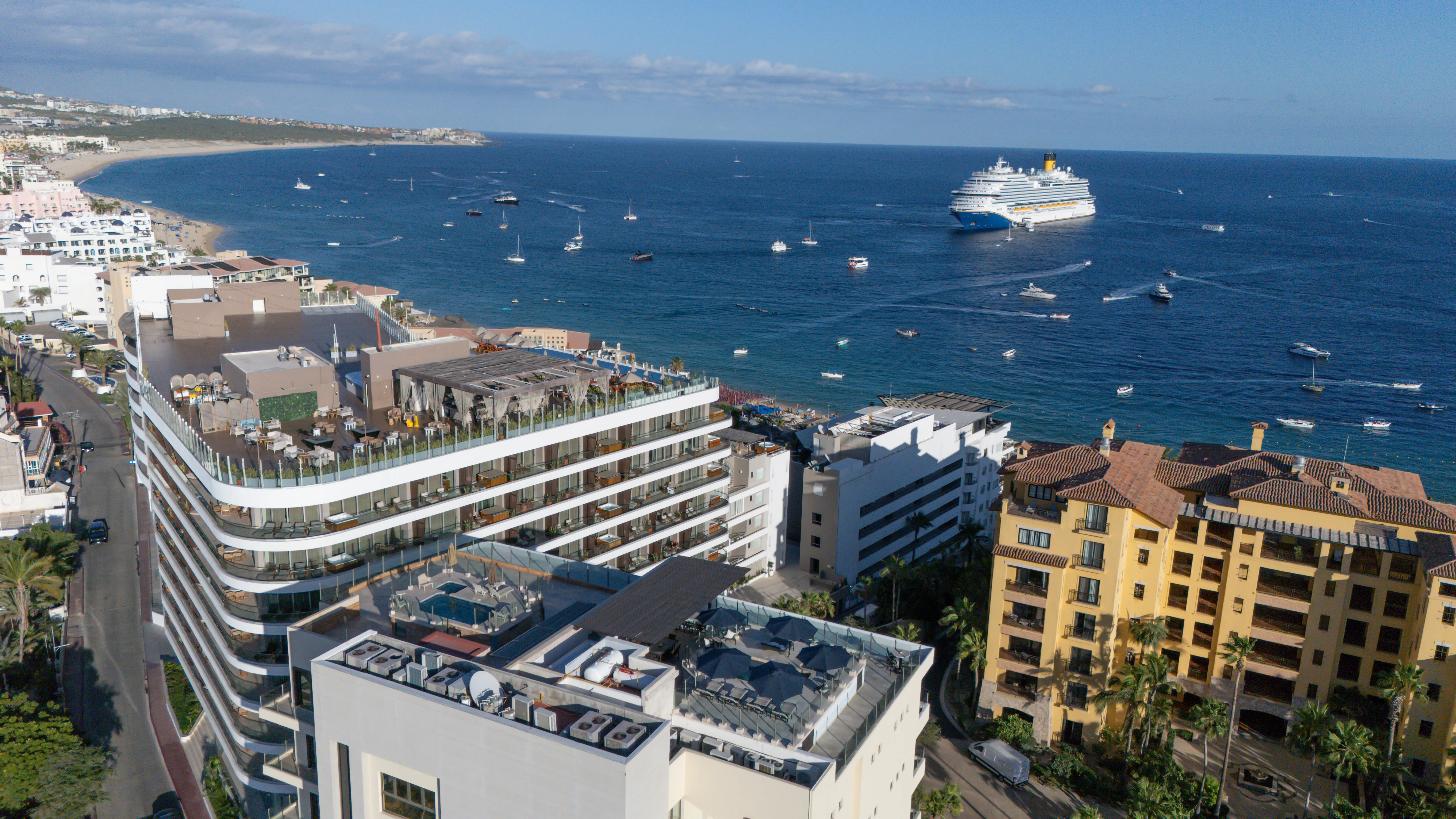Exterior view of the One Medano building featuring luxury ocean view condos in Cabo San Lucas.