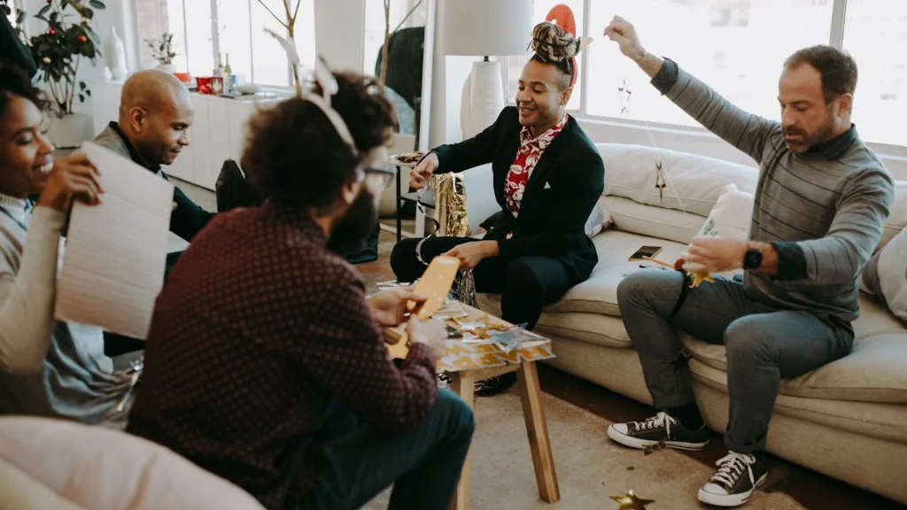 group doing an activity that they enjoy in a room with armchairs.