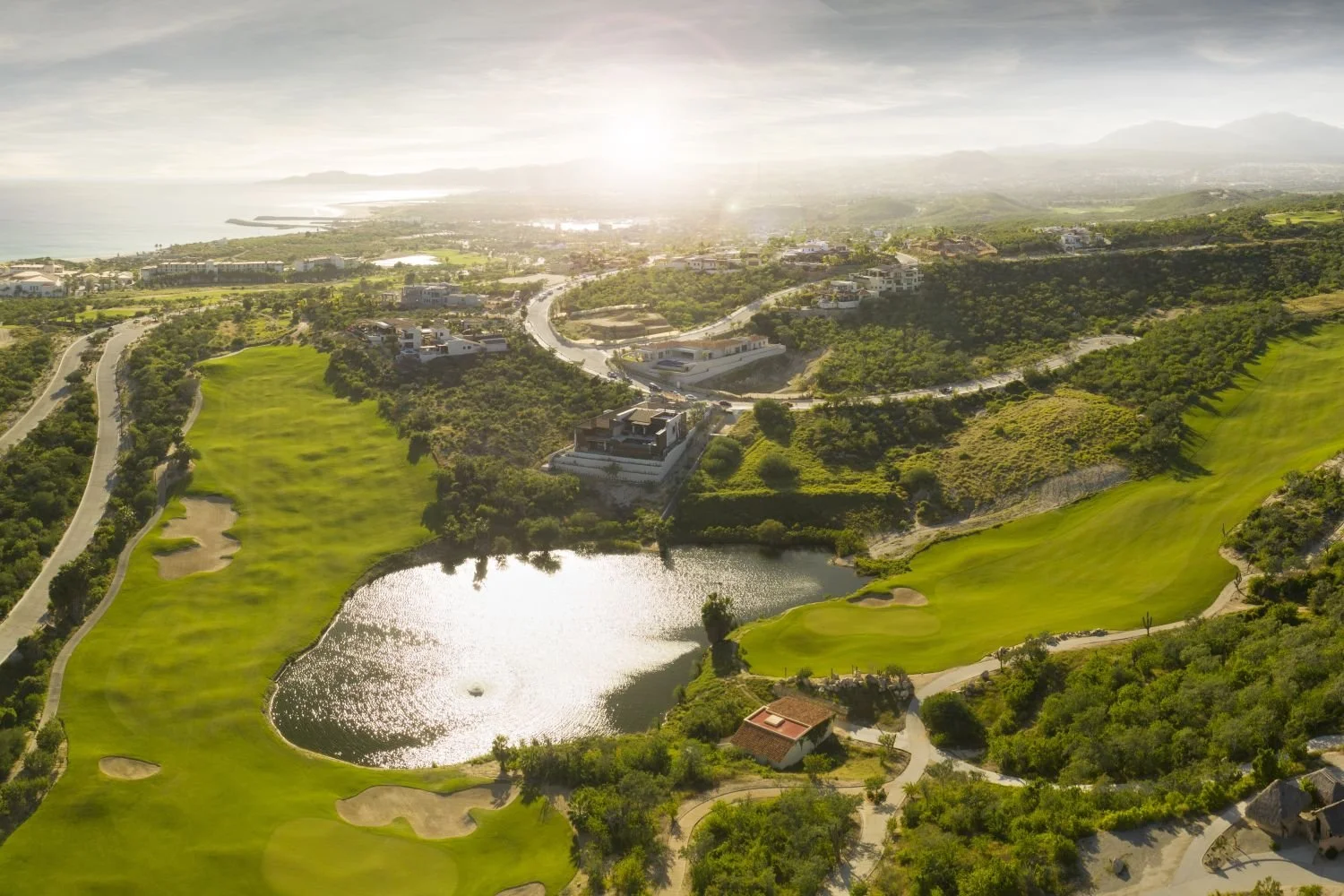 Aerial panoramic view of Puerto Los Cabos golf course and luxury residential developments with the Sea of Cortez in the background.